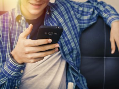 Teenager holding smartphone.