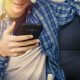 Teenager holding smartphone.